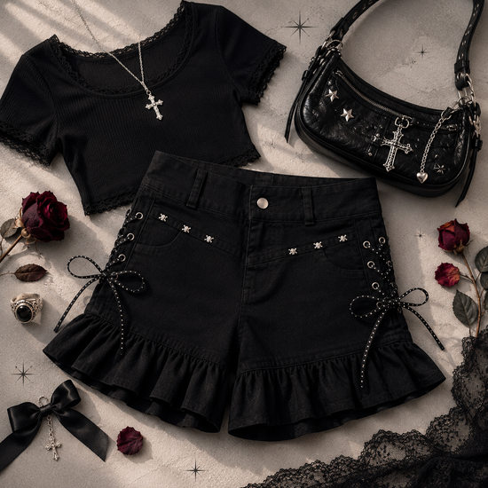 Two Moody Originals: Pretty Dangerous Shorts styled with a lace-trim top, gothic handbag, and silver accessories.