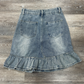Back flat lay of the Two Moody Originals: Ruffle Flare Jean Skirt with Angled Front in size M with ruffle hem.