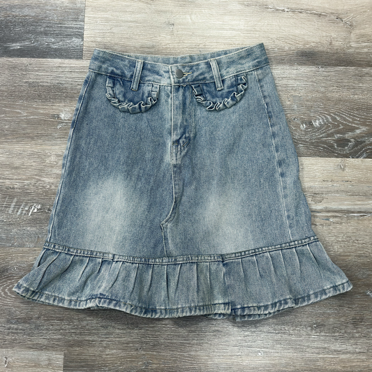 Front flat lay of the Two Moody Originals: Ruffle Flare Jean Skirt with Angled Front in size S with ruffle hem and ruffle faux pockets.