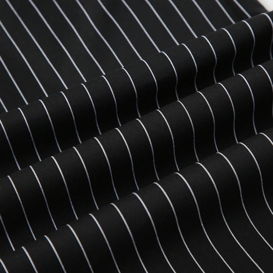 Close-up of Y2K Business Chic Trousers fabric showing crisp white pinstripes on smooth black broadcloth.