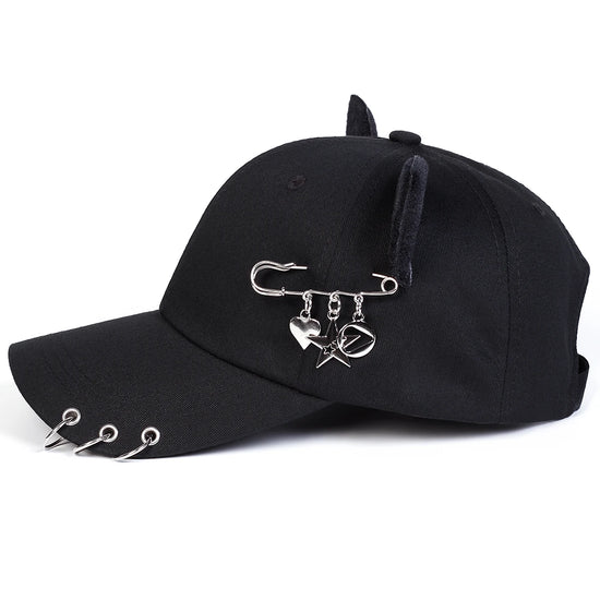 Side view of the black All-Star Kitty Baseball Cap showing the safety pin charms.