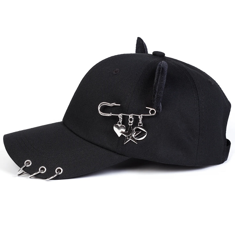 Side view of the black All-Star Kitty Baseball Cap showing the safety pin charms.