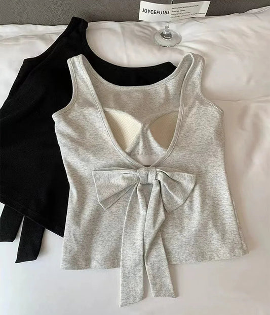 Black and gray Backstage Bow Backless Tanks are displayed together, with the gray version showing the back and the black version showing the front.