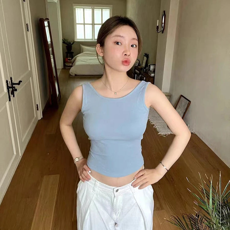 Model wearing the blue Backstage Bow Backless Tank, showing the front of the tank.
