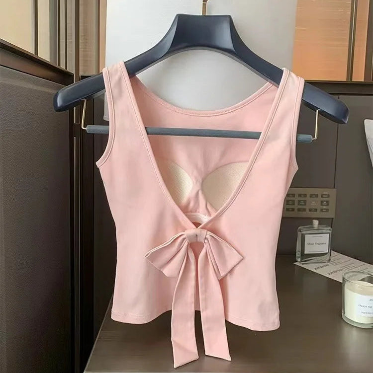 Pink Backstage Bow Backless Tank hanging to display the open back and bow.