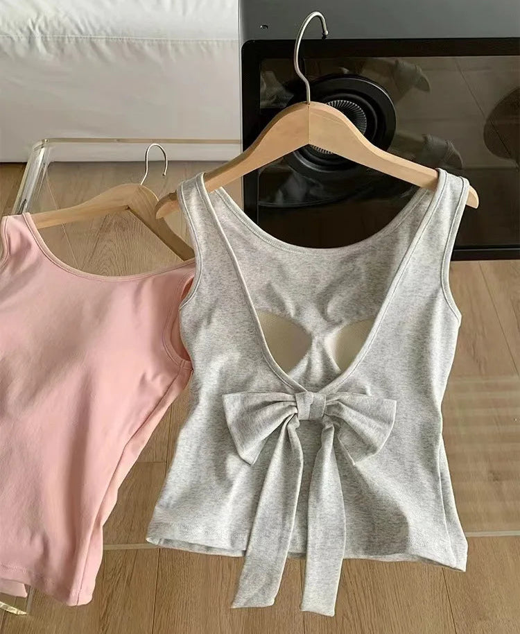 Back view of the gray Backstage Bow Backless Tank, featuring an oversized bow detail, next to the front view of the pink version.