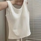 White Backstage Bow Backless Tank hanging from a model's arm, displaying the front.