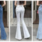 Model wearing the Backstage Bow Flare Jeans in dark blue, white, and light blue, back view.