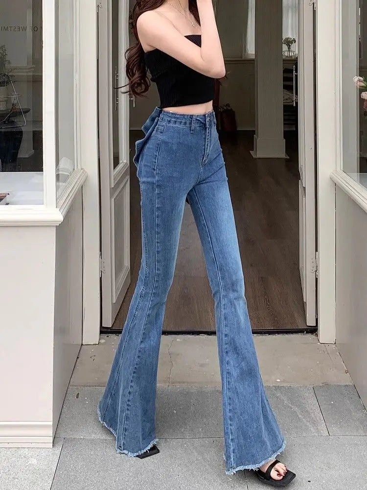 Model wearing the Dark Blue Backstage Bow Flare Jeans, angled front view.