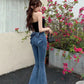 Mode posing and showing the back view of the Dark Blue Backstage Bow Flare Jeans.
