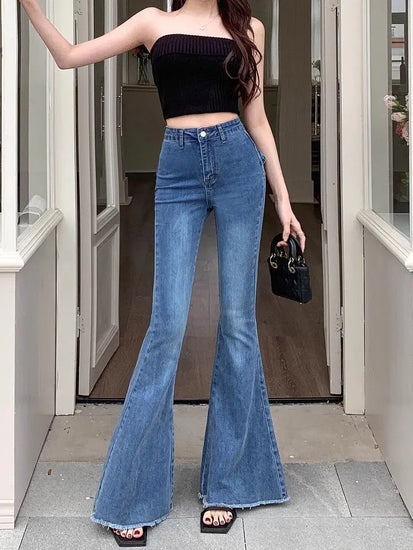Model wearing the Dark Blue Backstage Bow Flare Jeans, front view.