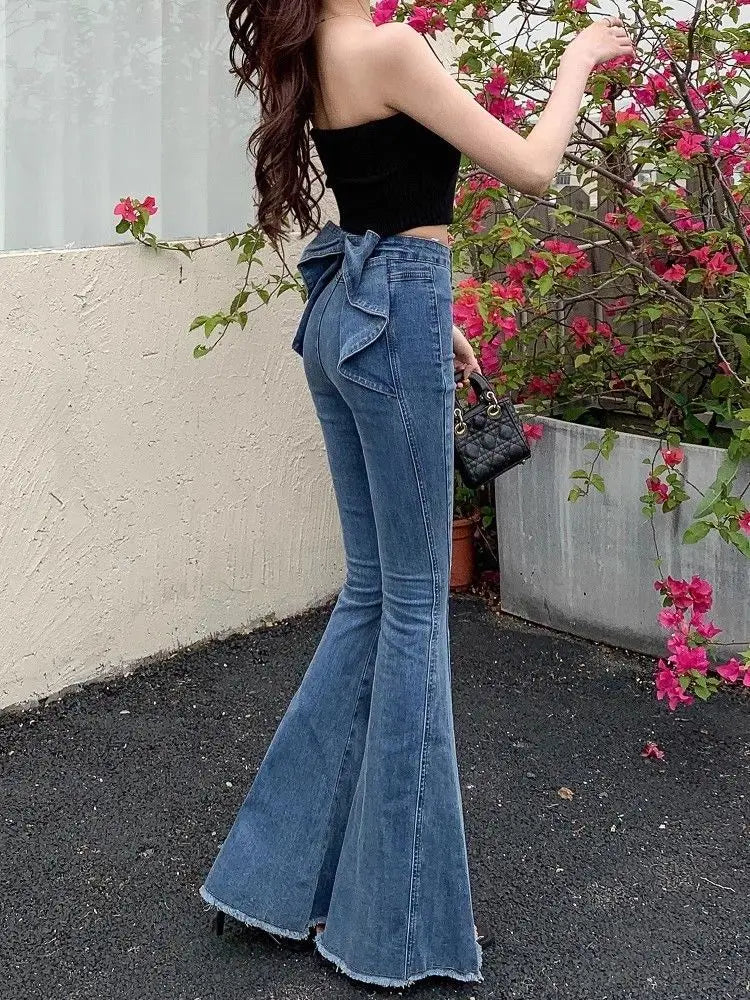 Side angle of the Dark Blue Backstage Bow Flare Jeans showing the slim-to-flare fit.