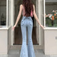 Model in a doorway showing the back view of the Light Blue Backstage Bow Flare Jeans highlighting the bow accent.