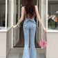 Model standing in a doorway showing the back view of the Light Blue Backstage Bow Flare Jeans highlighting the bow accent.