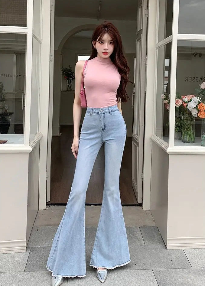 Model wearing the Light Blue Backstage Bow Flare Jeans, front view.