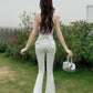 Model outdoors wearing the white Backstage Bow Flare Jeans.
