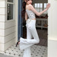 Side view of the white Backstage Bow Flare Jeans.