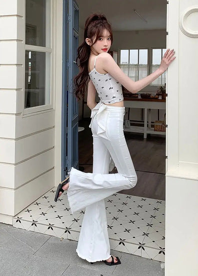 Side view of the white Backstage Bow Flare Jeans.