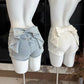 Back view of the white and light blue Backstage Bow Shorts displaying the oversized bow detail.