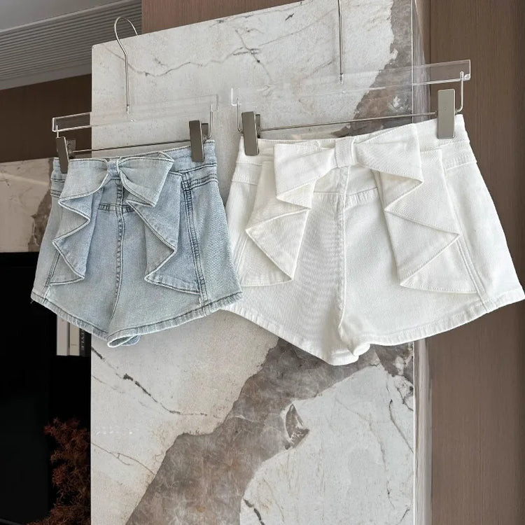 Light blue and white color options of the Backstage Bow Shorts hanging together.