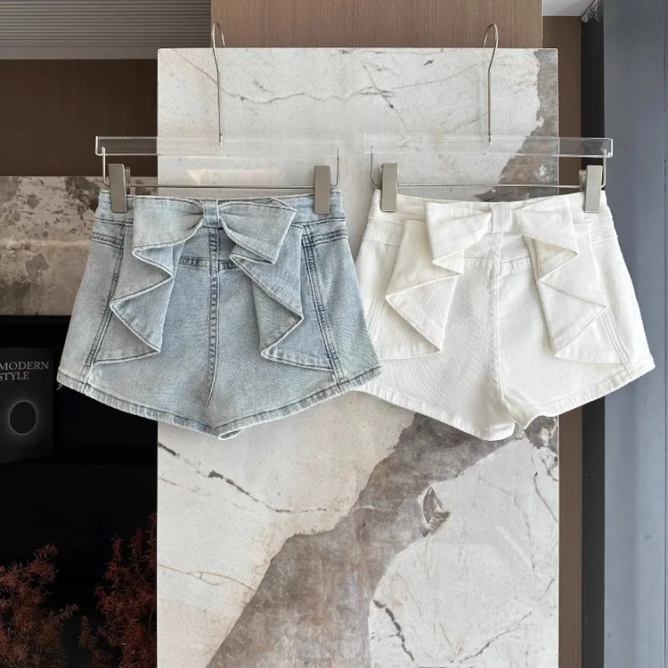 Light blue and white Backstage Bow Shorts hanging side by side.