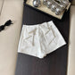 Back view of the white Backstage Bow Shorts.