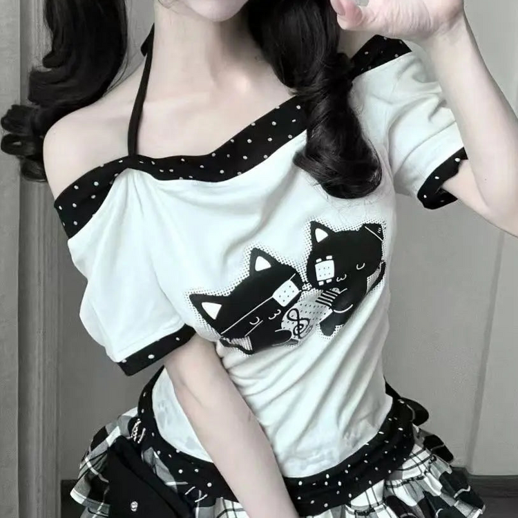Close-up of the model wearing the Bandaged Kitties Off-Shoulder Top highlighting the off-shoulder neckline, adjustable halter strap, contrasting polka dot trim, and bandaged kitty graphic.