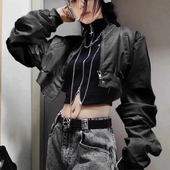 Model wearing the Blackout Zip Top layered under a black bomber jacket with grey acid-washed jeans.