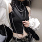Model styling the Blackout Zip Top with a crossbody bag, showcasing the mock neckline, ribbed fabric, and cropped silhouette.