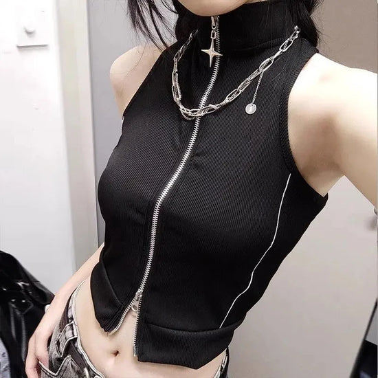 Front view of the model wearing the Blackout Zip Top featuring a two-way front zipper with a star zipper charm, high mock neckline, ribbed fabric, contrasting side piping, and cropped sleeveless design.