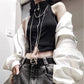 Model wearing the Blackout Zip Top layered under a white jacket, highlighting the cropped fit and two-way front zipper.