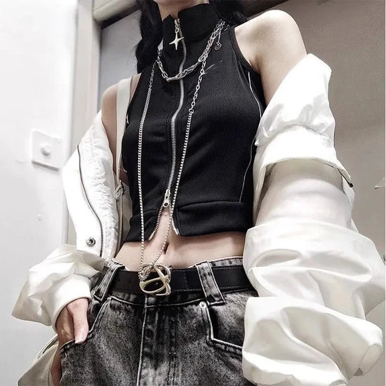 Model wearing the Blackout Zip Top layered under a white jacket, highlighting the cropped fit and two-way front zipper.