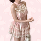 Three-quarter view of the Blushing Belle Skort Set worn by a model against a light pink heart background.