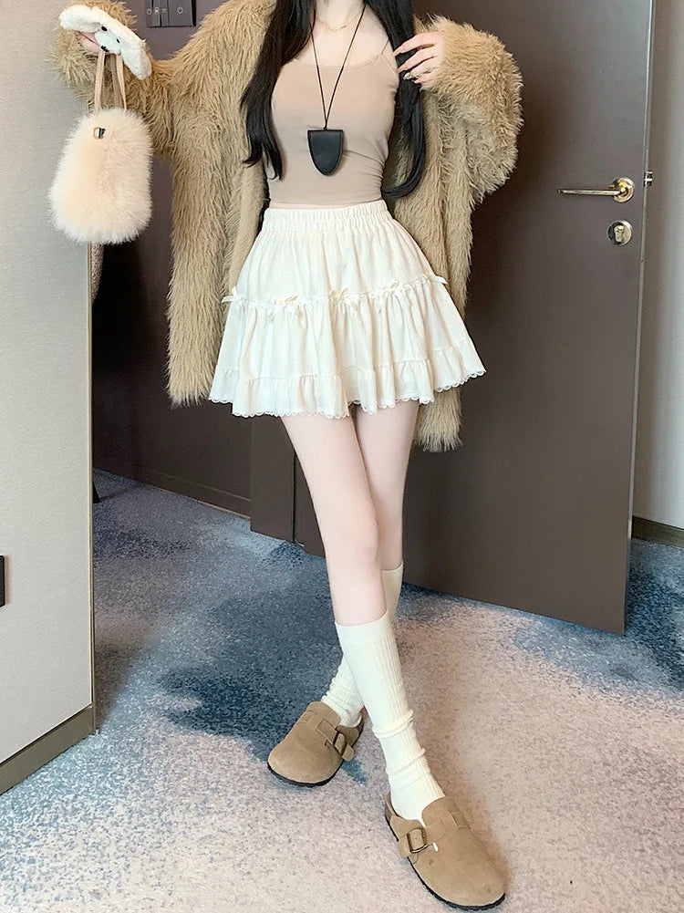 Model posing in the Bow Peep Mini Skort in Apricot.