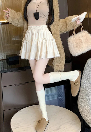 Side view of Bow Peep Mini Skort in Apricot showing lace-trim hem.