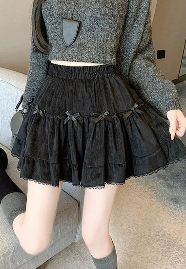 Close-up shot of Bow Peep Mini Skort in Black, showcasing its pleats and bows.