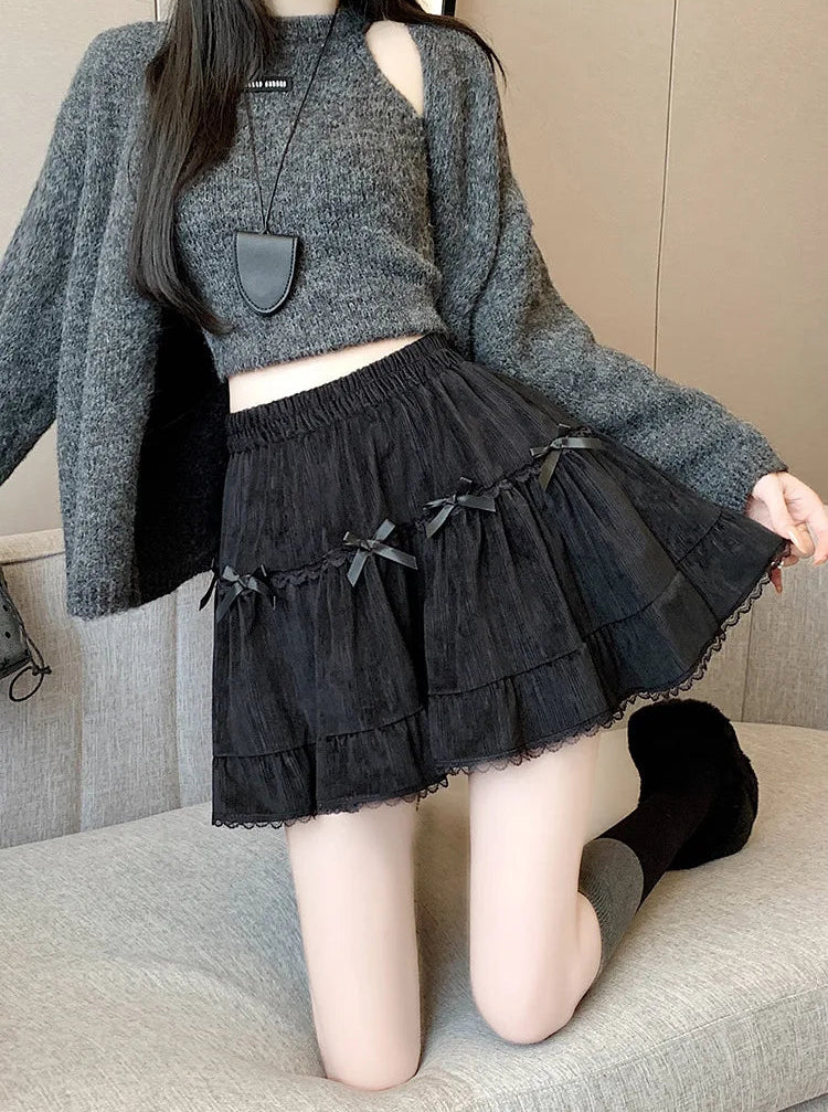 Detail shot of Bow Peep Mini Skort in Black with pleats and bows.