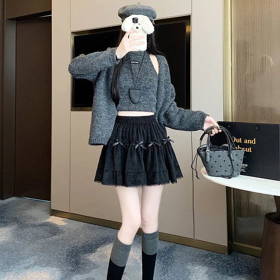 Model taking a selfie while wearing the Bow Peep Mini Skort in Black, pleated front view.