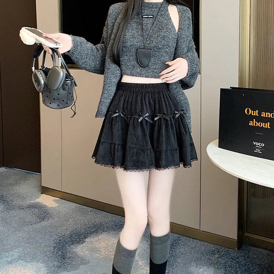 Model wearing Bow Peep Mini Skort in Black, pleated front view.