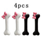 Four-piece Bowtiful Bones Hair Clips set, featuring two black and two white glossy bone-shaped hair clips with pink bow accents.