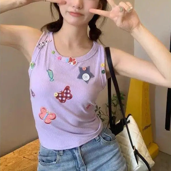 Model wearing the light lavender Charm Collector Tank and making a peace sign indoors.