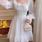 Model wearing the Cloudlight Fairy Dress while holding a mini purse with an embellished bow detail
