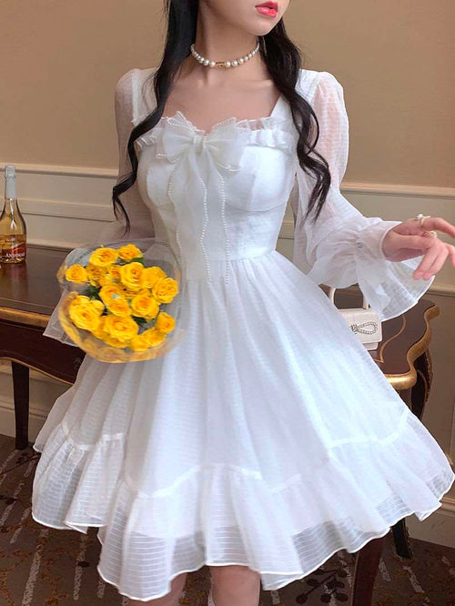 Model wearing the Cloudlight Fairy Dress with yellow bouquet, front view