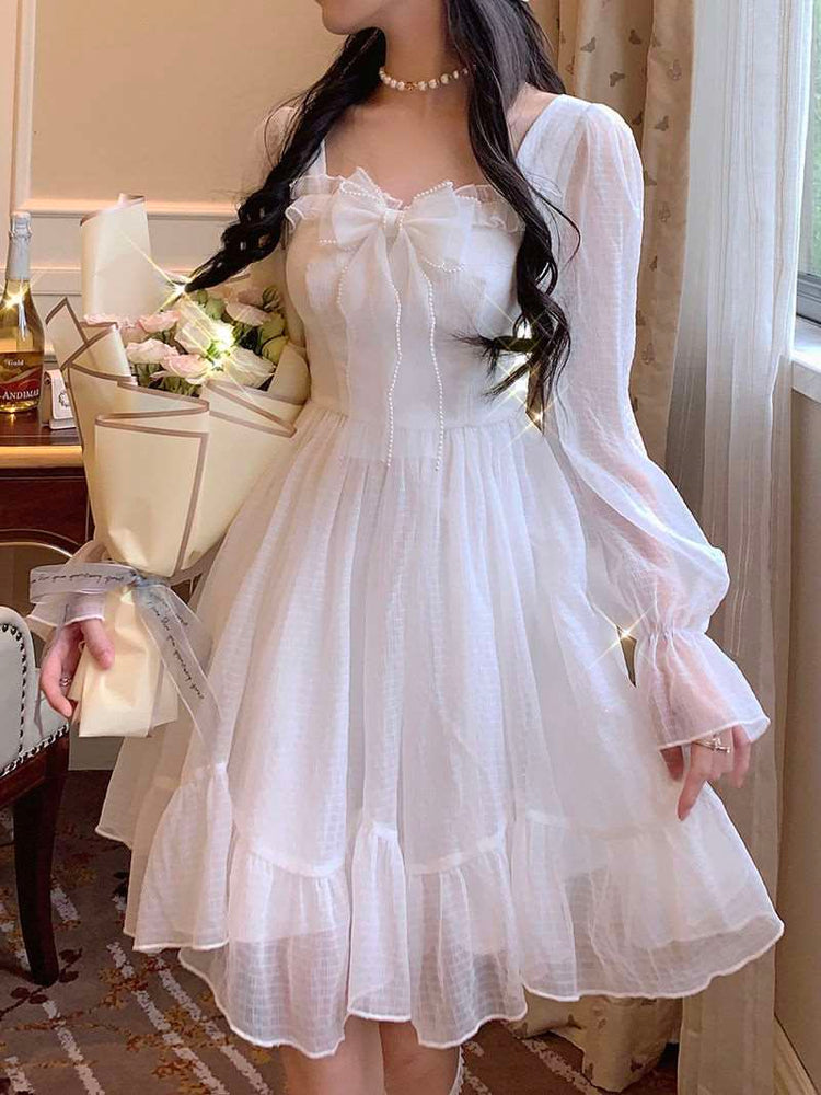 Model wearing the Cloudlight Fairy Dress while holding a bouquet of white and pink roses, front view