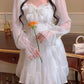 Model wearing the Cloudlight Fairy Dress while holding an orange rose