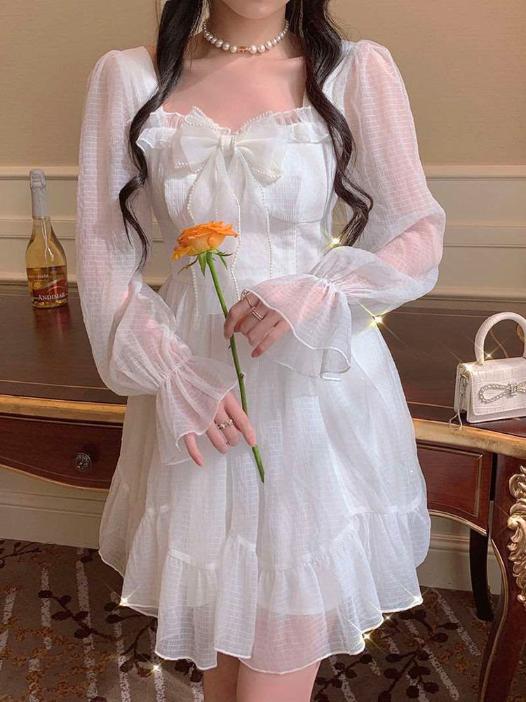 Model wearing the Cloudlight Fairy Dress while holding an orange rose