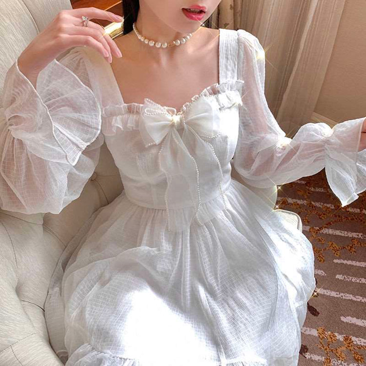 Model sitting in the Cloudlight Fairy Dress with added golden sparkles