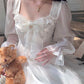 Model sitting in the Cloudlight Fairy Dress while holding a soft, brown teddy bear