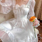 Model sitting in the Cloudlight Fairy Dress holding an orange rose