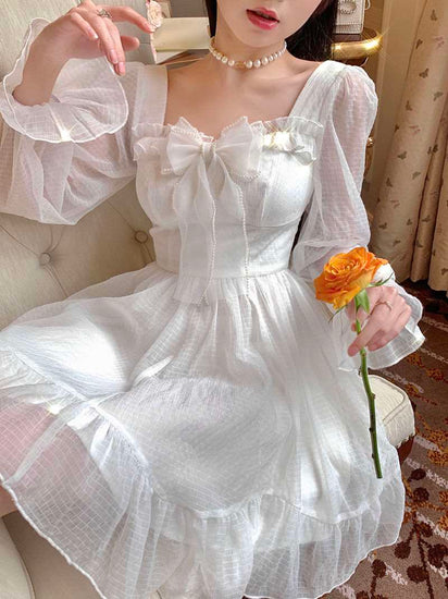 Model sitting in the Cloudlight Fairy Dress holding an orange rose